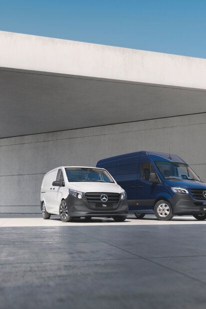 Ein weißer Mercedes-Benz Vito und ein dunkelblauer Sprinter stehen nebeneinander. 